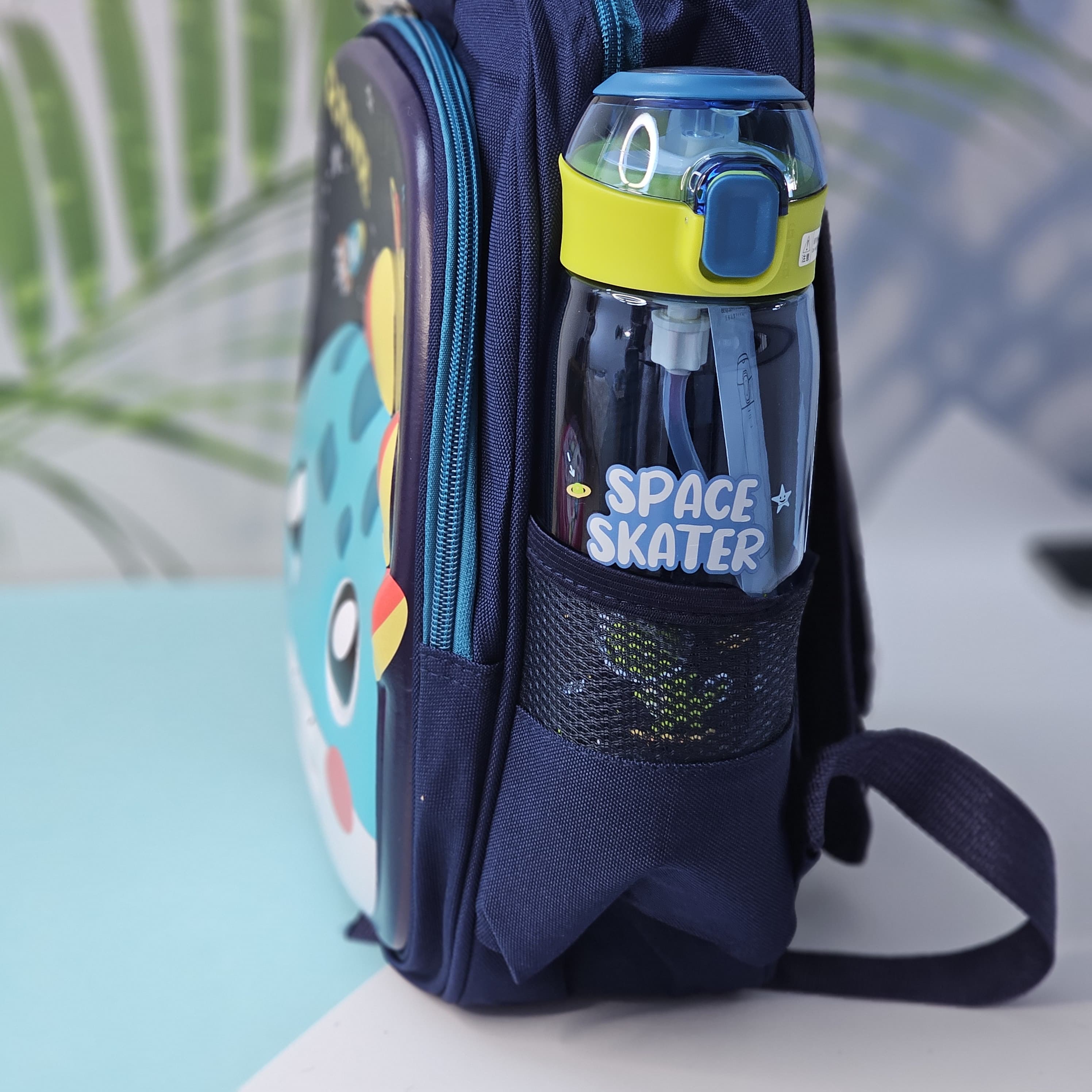 "Close-up of a Usmile Toys children's cartoon school backpack, designed in pink with a playful unicorn character on the front panel, and a matching pink water bottle in the side mesh pocket." www.usmile.toys
